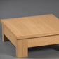Against a grey background, the square Oak Natural Fillet Centre Table, a wooden coffee and centre table inspired by Indian Bajot Table/Chowki you can buy online at Sukham Home, a sustainable furniture, kitchen & dining and home decor store in Kolkata, India