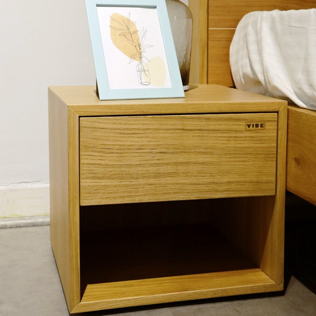 Close up of the wood grains on the Oak Natural Fred, a wooden bedside table with a drawer and cubby storage you can buy online at Sukham Home, a sustainable furniture, kitchen & dining and home decor store in Kolkata, India