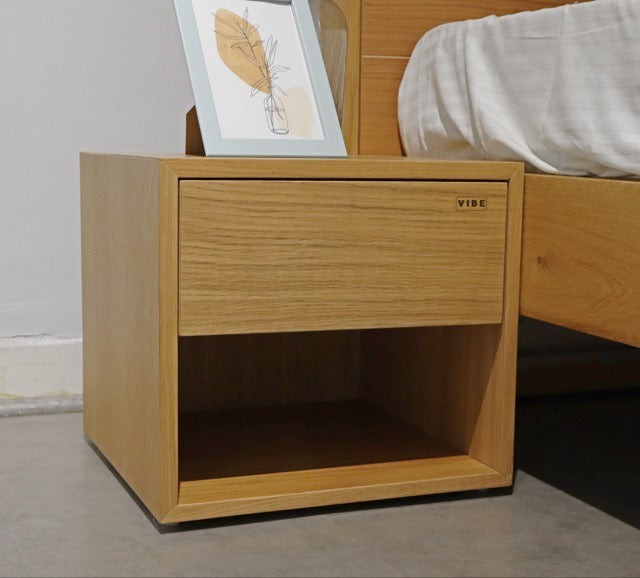 Oak Natural Fred, a wooden bedside table with a drawer and cubby storage you can buy online at Sukham Home, a sustainable furniture, kitchen & dining and home decor store in Kolkata, India