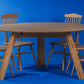 Level view of the Oak Antique Full Moon Dining Table, a wooden 4 and 6-seater round dining table you can buy online at Sukham Home, a sustainable furniture, kitchen & dining and home decor store in Kolkata, India