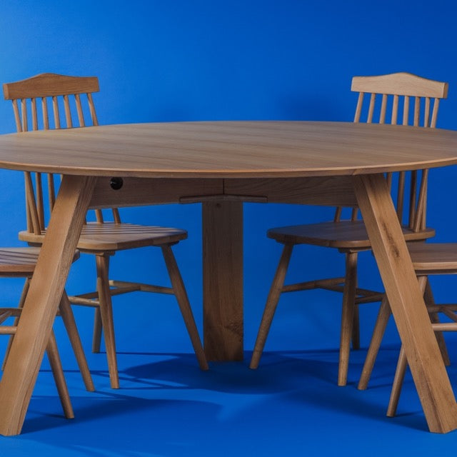 Level view of the Oak Antique Full Moon Dining Table, a wooden 4 and 6-seater round dining table you can buy online at Sukham Home, a sustainable furniture, kitchen & dining and home decor store in Kolkata, India