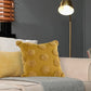 Arranged on a cream sofa, the Gold Tufted Dots Cushion, a square yellow accent pillow available at Sukham Home, a sustainable furniture, kitchen & dining and home decor store in Kolkata, India
