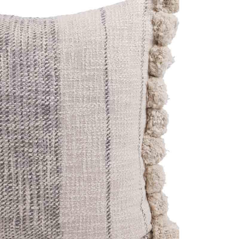 Close up of the woven texture of the Graphite Cushions, a set of two white and grey linen accent pillows with pom poms you can buy online at Sukham Home, a sustainable furniture, kitchen & dining and home decor store in Kolkata, India