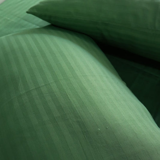 Close up of the fabric and texture of the Green Sateen Striped Bedsheet, a king size cotton bedsheet you can buy online at Sukham Home, a sustainable furniture, gardening and home decor store in Kolkata, India