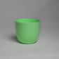 A single green Verona, a round colourful indoor planter made from plastic that you can buy online at Sukham Home, a sustainable furniture, gardening and home decor store in Kolkata, India