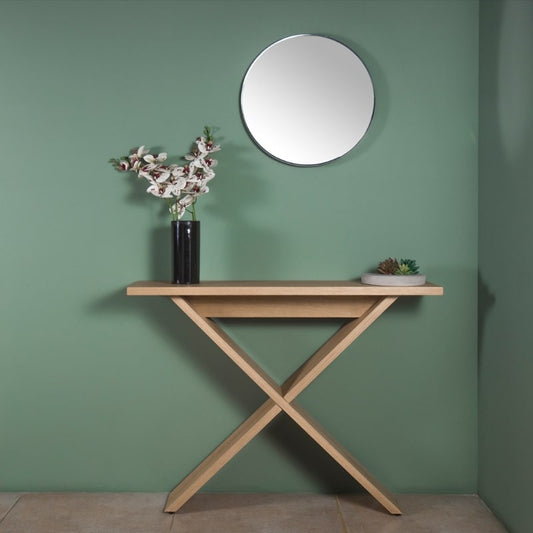Against a green wall with a round mirror, the Oak Natural Greet, a wooden entryway console you can buy online at Sukham Home, a sustainable furniture, kitchen & dining and home decor store in Kolkata, India