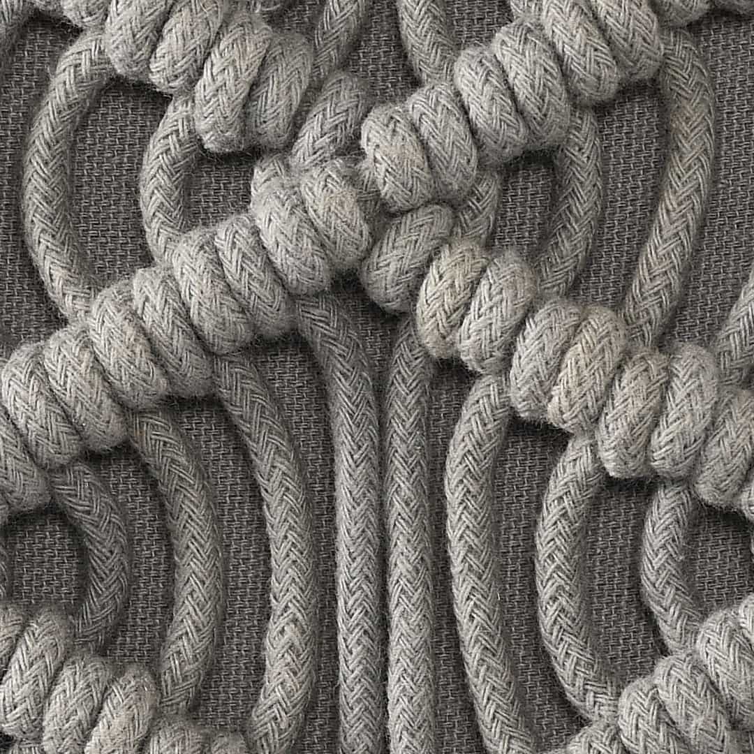 Close up of the design and texture of the Grey Macrame Cushion, a rectangle accent pillow you can buy online at Sukham Home, a sustainable furniture, kitchen & dining and home decor store in Kolkata, India