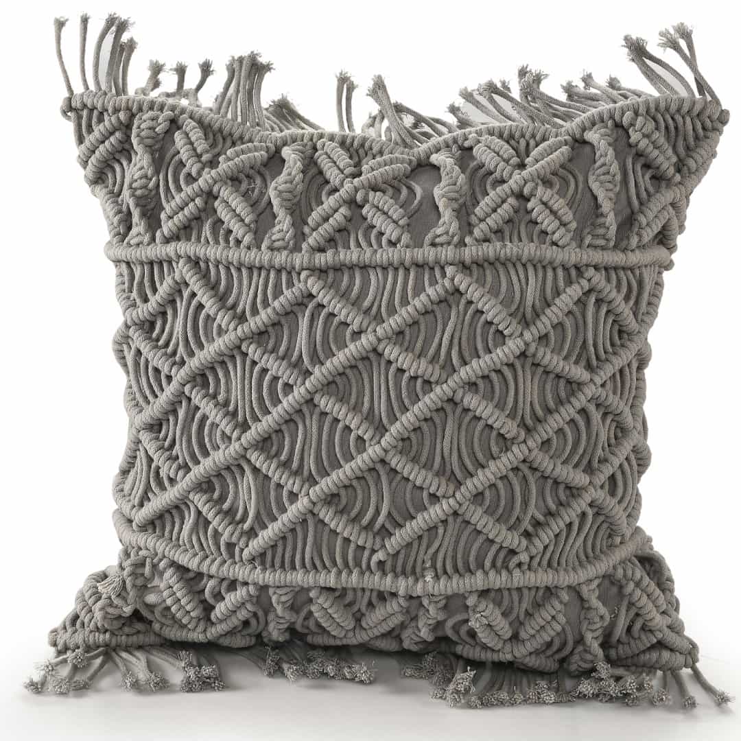 Against a white background, the Grey Macrame Cushion, a square accent pillow you can buy online at Sukham Home, a sustainable furniture, kitchen & dining and home decor store in Kolkata, India