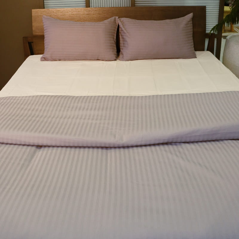 Both pillow covers and the duvet of the Grey Striped Egyptian Cotton Duvet Cover, a silver king size duvet cover you can buy online at Sukham Home, a sustainable furniture, gardening and home decor store in Kolkata, India