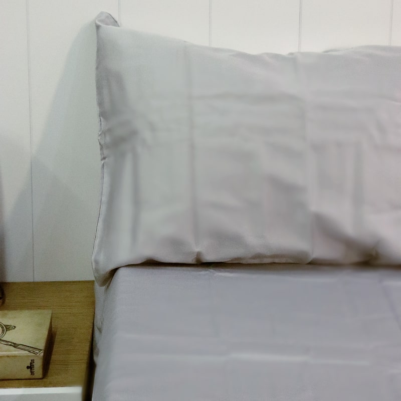 A pillow case and the sheet of the Silver Grey Classic Solid Bedsheet, a king size and queen size cotton bedsheet you can buy online at Sukham Home, a sustainable furniture, gardening and home decor store in Kolkata, India