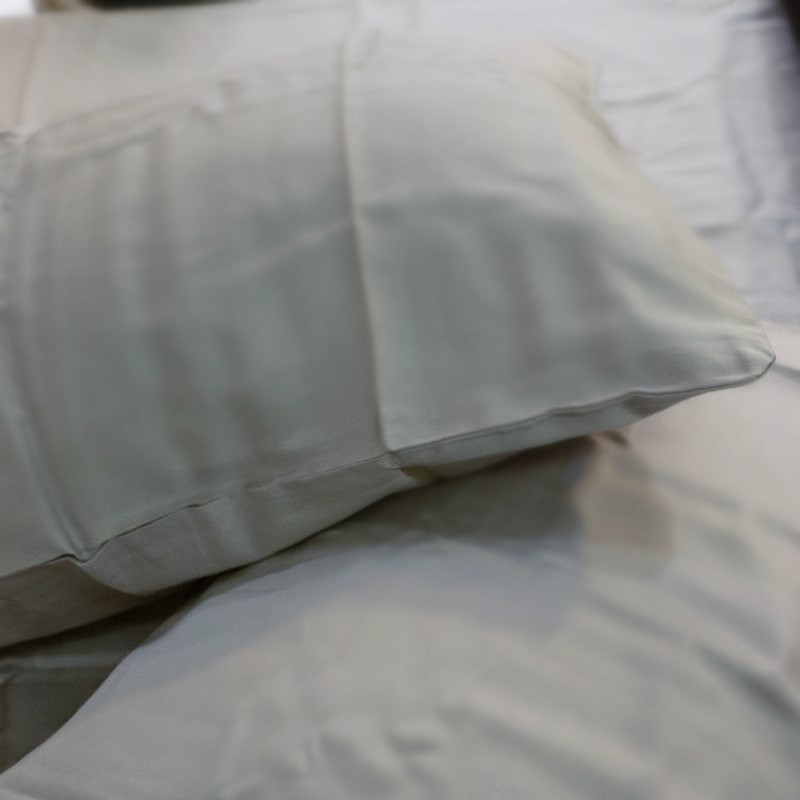 Close up of the two pillow cases on the Silver Grey Classic Solid Bedsheet, a king size and queen size cotton bedsheet you can buy online at Sukham Home, a sustainable furniture, gardening and home decor store in Kolkata, India