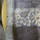 Hand towels with white and gold embroidery from the Grey & Beige Silly-Cuddly, a set of 8 floral embroidered towels you can buy online at Sukham Home, a sustainable furniture, kitchen & dining and home decor store in Kolkata, India