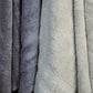Close up of the bath towels from the Grey & Beige Silly-Cuddly, a set of 8 floral embroidered towels you can buy online at Sukham Home, a sustainable furniture, kitchen & dining and home decor store in Kolkata, India