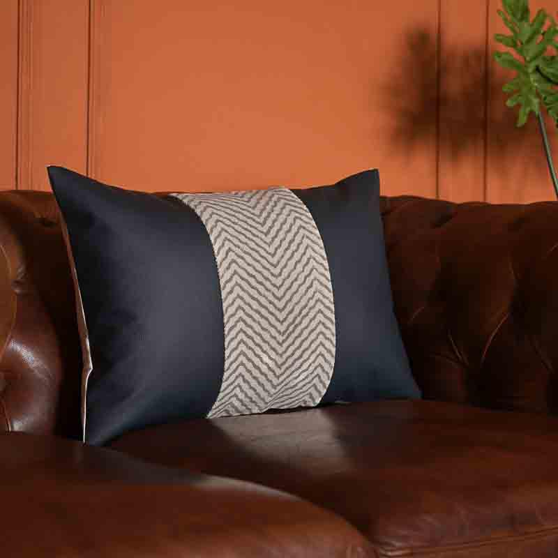 Side view of the Hailey Cushion, a black leatherette cotton handpainted rectangle accent pillow you can buy online at Sukham Home, a sustainable furniture, kitchen & dining and home decor store in Kolkata, India