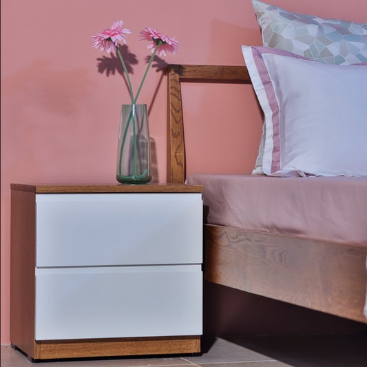 In Oak Antique with white PU finish, Hygge, a wooden bedside table with two drawer storage you can buy online at Sukham Home, a sustainable furniture, kitchen & dining and home decor store in Kolkata, India