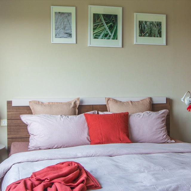 Front view of the headboard of the Hymn, a wooden bed with a wood slatted framed headboard you can buy online at Sukham Home, a sustainable furniture, kitchen & dining and home decor store in Kolkata, India