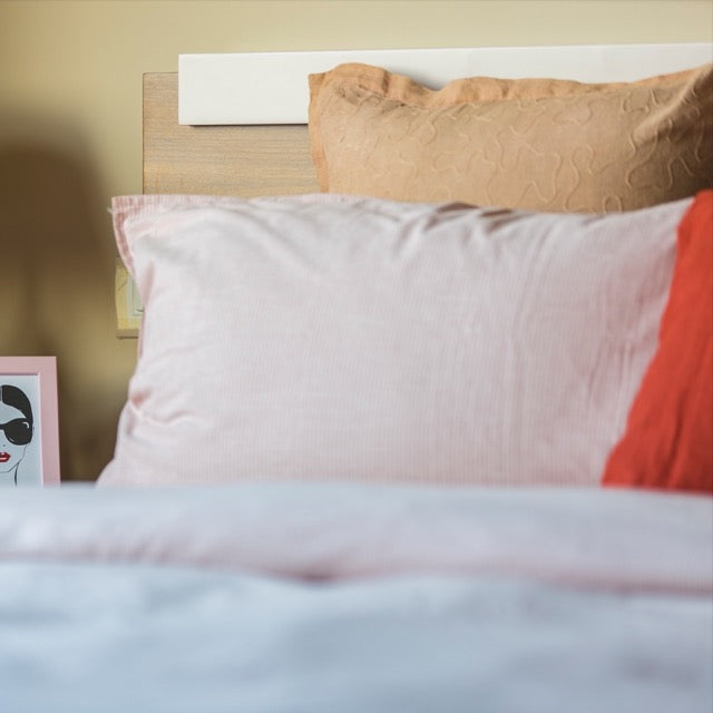 Close up of the slatted headboard of Hymn, a wooden bed with a wood slatted framed headboard you can buy online at Sukham Home, a sustainable furniture, kitchen & dining and home decor store in Kolkata, India