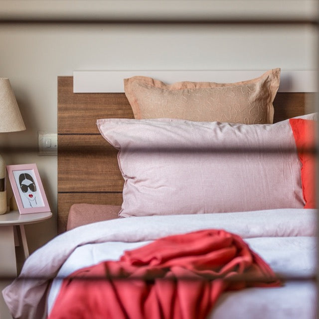 Detailed view of the panelled wood headboard of the Walnut Natural Hymn, a wooden bed with a wood slatted framed headboard you can buy online at Sukham Home, a sustainable furniture, kitchen & dining and home decor store in Kolkata, India