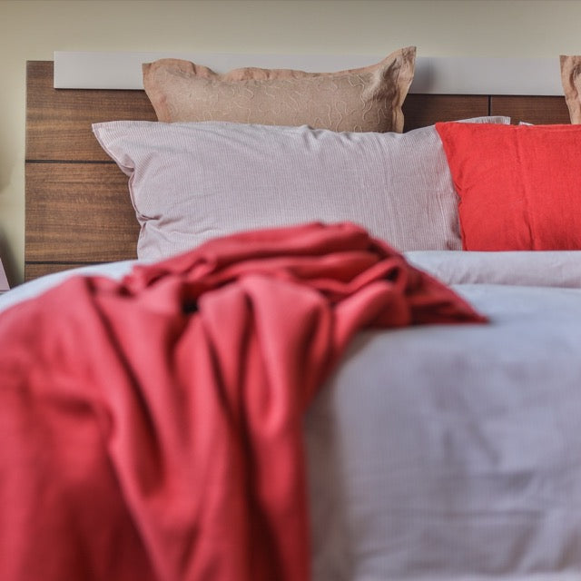 View of the wood grains on the headboard of the Walnut Natural Hymn, a wooden bed with a wood slatted framed headboard you can buy online at Sukham Home, a sustainable furniture, kitchen & dining and home decor store in Kolkata, India