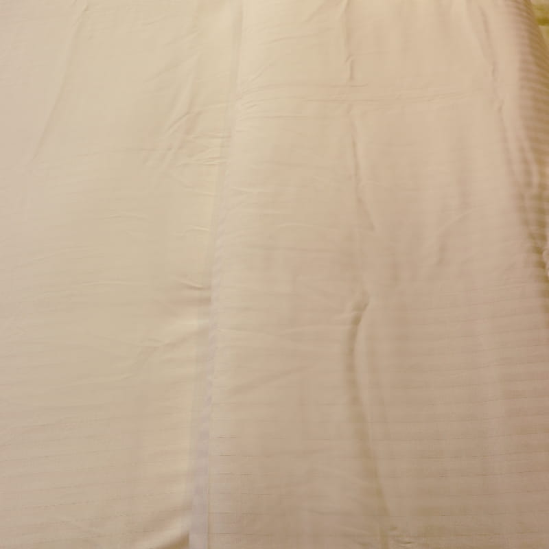 Close up of the Ivory Striped Egyptian Cotton Duvet Cover, a white king size duvet cover you can buy online at Sukham Home, a sustainable furniture, gardening and home decor store in Kolkata, India