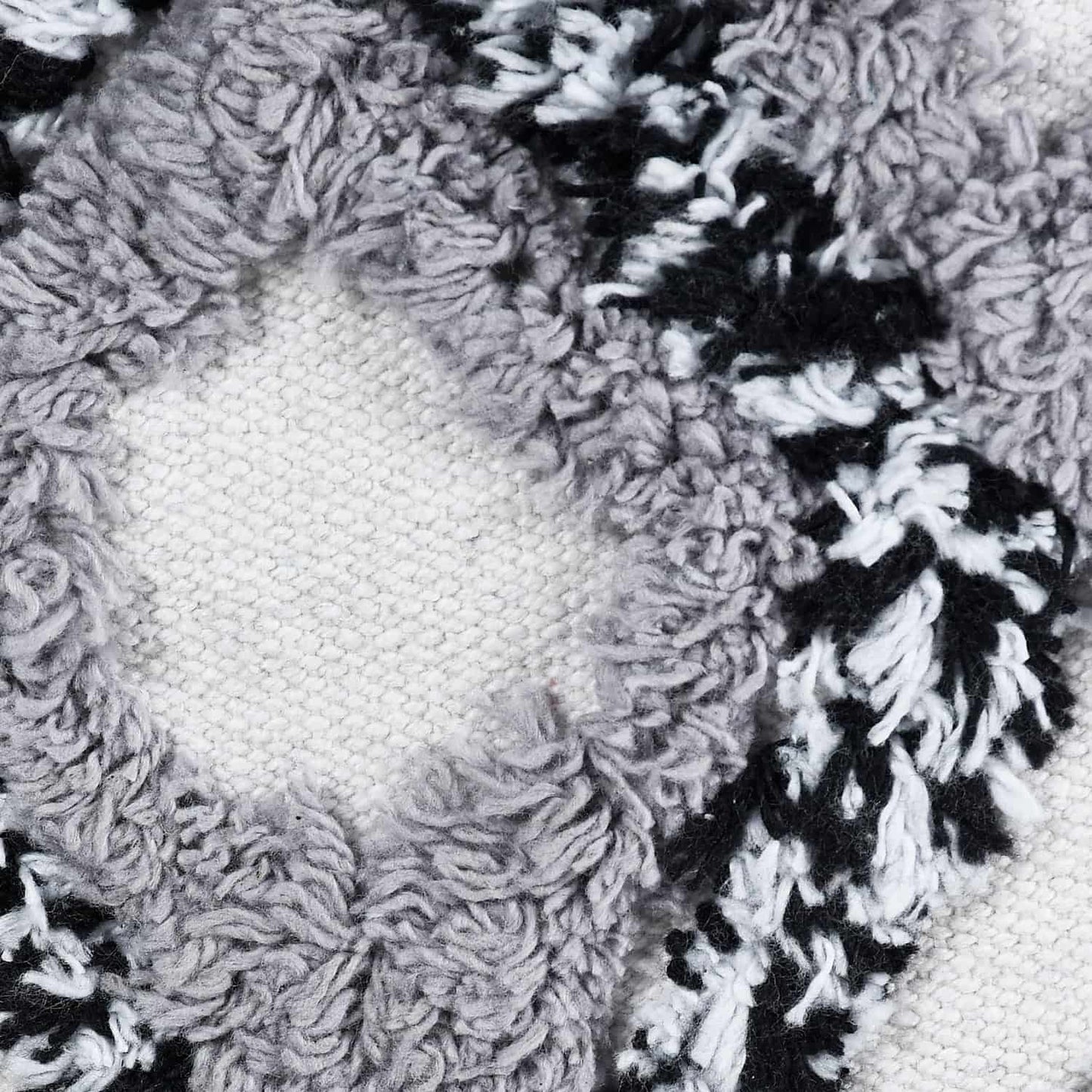 Close up of the tufting pattern on the Ivory White and Black Diamond Tufted Pouf, an ottoman made from cotton, available at Sukham Home, a sustainable furniture, kitchen & dining and home decor store in Kolkata, India