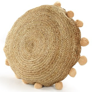 Tilted view of the Jute Round Floor Cushion, a circular braided accent pillow with pom poms, available at Sukham Home, a sustainable furniture, kitchen & dining and home decor store in Kolkata, India