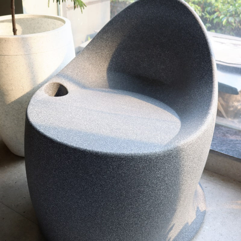 Side view of Grey Stone Marvella Chair, a stone finish plastic outdoor furniture chair you can buy online at Sukham Home, a sustainable furniture, kitchen & dining and home decor store in Kolkata, India