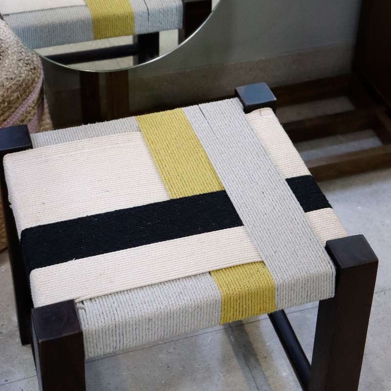 Placed near a mirror, the Mondrian Jodhpur Stool, a cotton ottoman inspired by Mondrian colour blocking paintings, available at Sukham Home, a sustainable furniture, kitchen & dining and home decor store in Kolkata, India