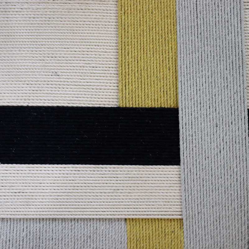 Close up of the weaving pattern of the Mondrian Jodhpur Stool, a cotton ottoman inspired by Mondrian colour blocking paintings, available at Sukham Home, a sustainable furniture, kitchen & dining and home decor store in Kolkata, India