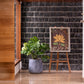 In a corner of the house, the Grey Ceramic Pearl, a round textured luxury planter made from FRP you can buy online at Sukham Home, a sustainable furniture, gardening and home decor store in Kolkata, India