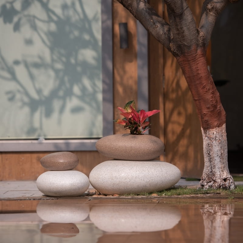 In all three sizes, in Sand Stone and White Stone finishes, the Pebble, a rock-shaped stone finish plastic planter that looks like granite available at Sukham Home, a sustainable furniture, gardening and home decor store in Kolkata, India