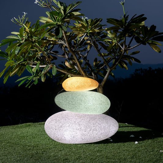 In White Stone and Sand Stone, the Pebble with LED, a rock-shaped stone finish plastic planter with light that looks like granite available at Sukham Home, a sustainable furniture, gardening and home decor store in Kolkata, India