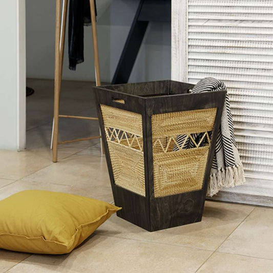 Used in a laundry room, the Pile Laundry Basket, a laundry bag made from golden grass that you can buy online at Sukham Home, a sustainable furniture, kitchen & dining and home decor store in Kolkata, India