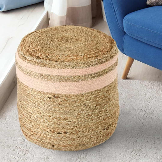 Placed next to a sofa, the Jute Pouf with Pink Accent, a braided and stitched ottoman made from jute & cotton, available at Sukham Home, a sustainable furniture, kitchen & dining and home decor store in Kolkata, India