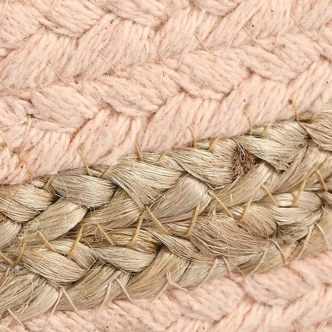 Close up of the texture on the Jute Pouf with Pink Accent, a braided and stitched ottoman made from jute & cotton, available at Sukham Home, a sustainable furniture, kitchen & dining and home decor store in Kolkata, India