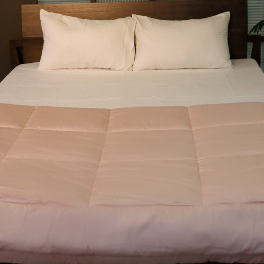 Front view of the Pink Solid Comforter, a pink king size cotton bedsheet you can buy online at Sukham Home, a sustainable furniture, gardening and home decor store in Kolkata, India