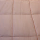 Close up of the texture and fabric of the Pink Solid Comforter, a pink king size cotton bedsheet you can buy online at Sukham Home, a sustainable furniture, gardening and home decor store in Kolkata, India