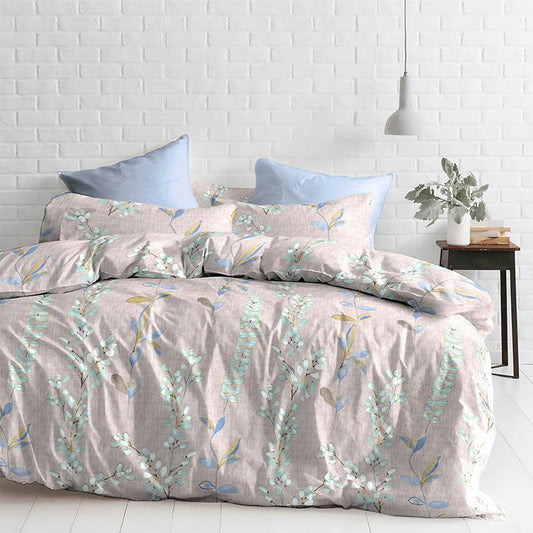 Arranged on a bed, the Pink Spruce Floral Printed Bedsheet, a pastel king size cotton bedsheet you can buy online at Sukham Home, a sustainable furniture, gardening and home decor store in Kolkata, India
