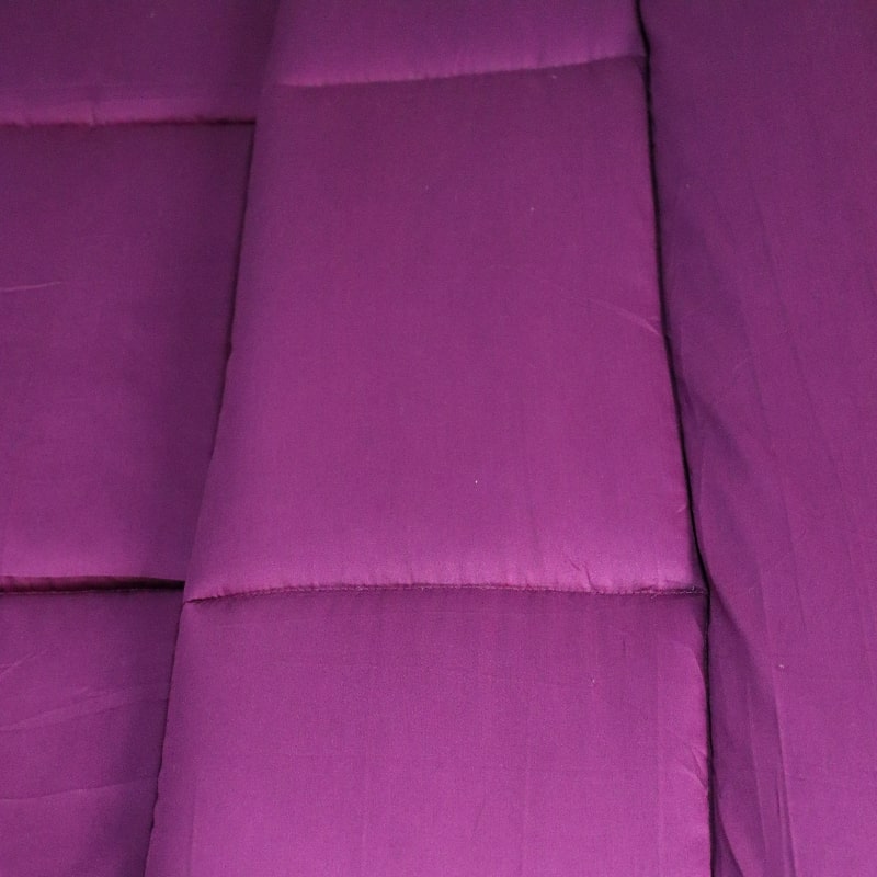 Close up of the texture and fabric of the Plum Solid Comforter, a purple king size cotton bedsheet you can buy online at Sukham Home, a sustainable furniture, gardening and home decor store in Kolkata, India