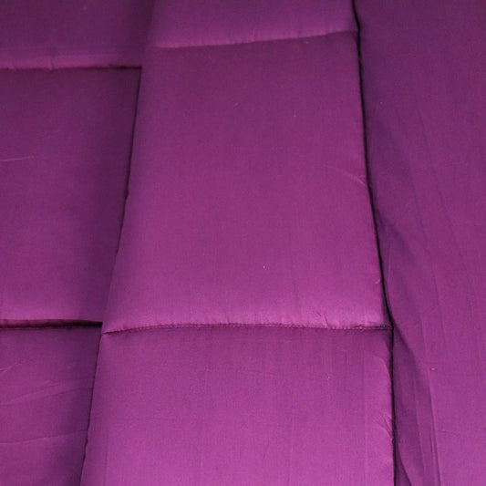 Close up of the texture and fabric of the Plum Solid Comforter, a purple king size cotton bedsheet you can buy online at Sukham Home, a sustainable furniture, gardening and home decor store in Kolkata, India