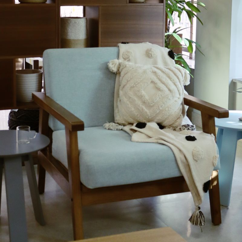 Using Snow blue fabric, the Oak Antique Poise Armchair, a wooden cushioned midcentury seat you can buy online at Sukham Home, a sustainable furniture, kitchen & dining and home decor store in Kolkata, India