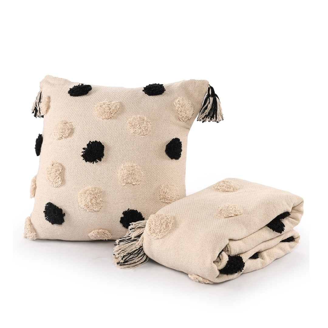 Against a white background, the Monochromatic Polka Dot Throw, a black and white throw you can buy online at Sukham Home, a sustainable furniture, kitchen & dining and home decor store in Kolkata, India