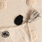 The tasseled corners and reverse side of the Monochromatic Polka Dot Throw, a black and white throw you can buy online at Sukham Home, a sustainable furniture, kitchen & dining and home decor store in Kolkata, India