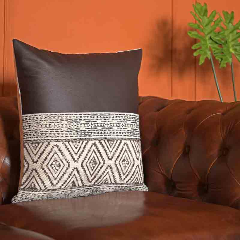 Side view of the Querencia Cushion, a black leatherette cotton handpainted and tufted accent pillow you can buy online at Sukham Home, a sustainable furniture, kitchen & dining and home decor store in Kolkata, India