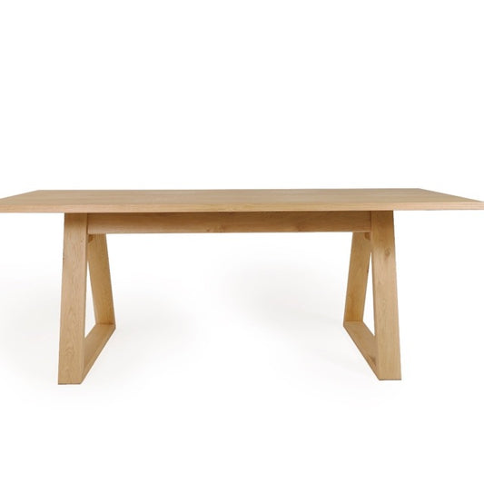 Against a white background, side view of the Renuir, a wooden 6-seater rectangle dining table you can buy online at Sukham Home, a sustainable furniture, kitchen & dining and home decor store in Kolkata, India