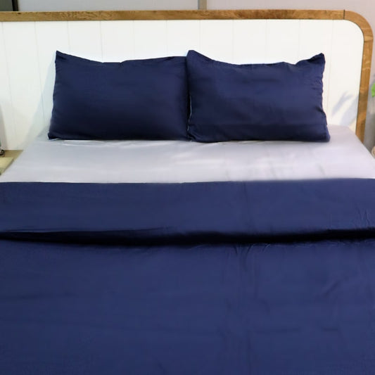 Navy blue side of both pillow covers and duvet of the Navy Blue-Sky Blue Reversible Egyptian Cotton Duvet Cover, a dual king size duvet cover you can buy online at Sukham Home, a sustainable furniture, gardening and home decor store in Kolkata, India