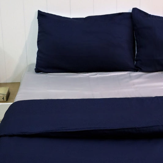 One navy blue pillow cover and duvet of the Navy Blue-Sky Blue Reversible Egyptian Cotton Duvet Cover, a dual king size duvet cover you can buy online at Sukham Home, a sustainable furniture, gardening and home decor store in Kolkata, India