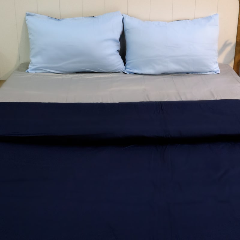 Both sky blue pillow cover and navy blue duvet of the Navy Blue-Sky Blue Reversible Egyptian Cotton Duvet Cover, a dual king size duvet cover you can buy online at Sukham Home, a sustainable furniture, gardening and home decor store in Kolkata, India