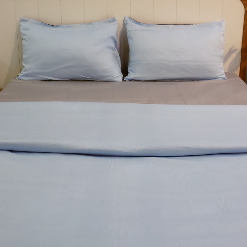 Both sky blue pillow cases and sky blue duvet side of the Navy Blue-Sky Blue Reversible Egyptian Cotton Duvet Cover, a dual king size duvet cover you can buy online at Sukham Home, a sustainable furniture, gardening and home decor store in Kolkata, India