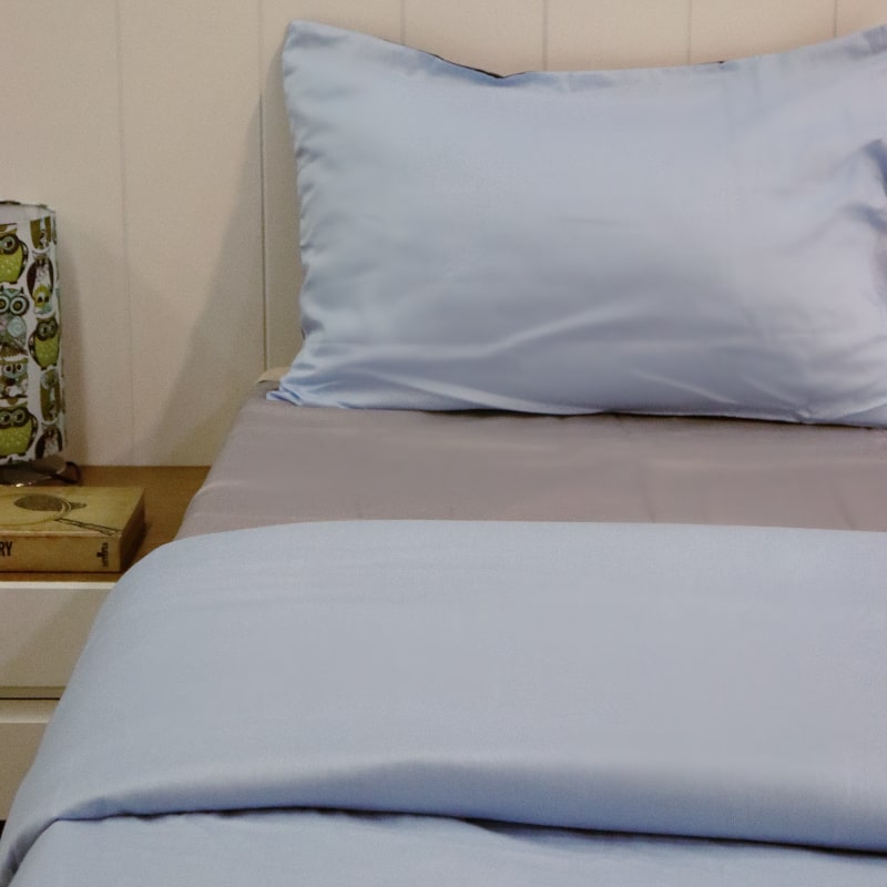 One sky blue pillow cover and sky blue duvet side of the Navy Blue-Sky Blue Reversible Egyptian Cotton Duvet Cover, a dual king size duvet cover you can buy online at Sukham Home, a sustainable furniture, gardening and home decor store in Kolkata, India